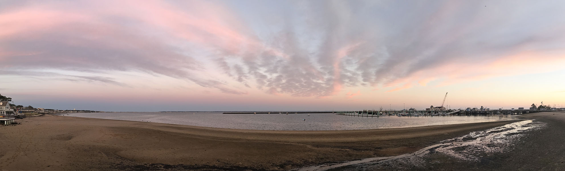 Colorpanoramic Photo of Beach, Harbor, and Sunset.